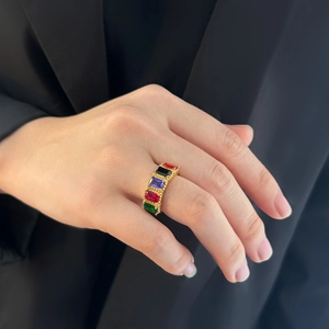Close-up of vintage titanium steel ring with colorful zircon stones on model's finger