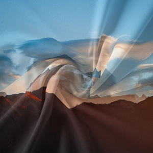 Detail shot of mountain landscape printed fabric showing fine texture and silk-like drape