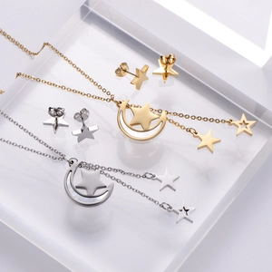 Macro view of gold and silver celestial moon and star jewelry set on acrylic blocks