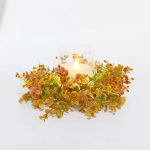 Detail view of autumn eucalyptus wreath with glass holder and warm LED candle light