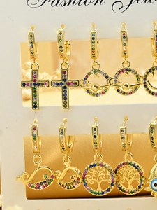 Detail of colorful cubic zirconia charms with gold plating and various symbolic icons