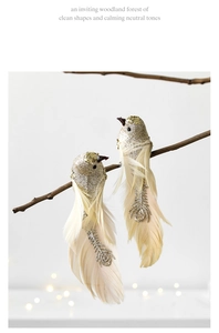 Detailed view of two elegant glitter birds with feathers on a branch for Christmas decor