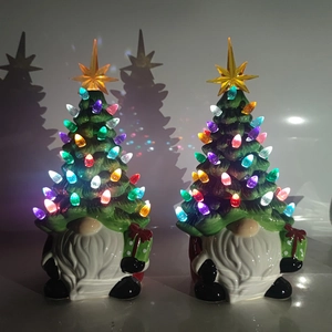 Pair of lighted ceramic Christmas gnomes with colorful tree hats and gift boxes