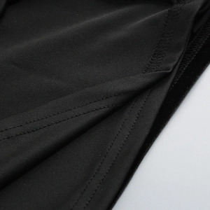Close-up of fine knit fabric texture and high-quality double-needle stitching on black dress