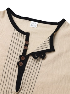 Macro detail of men's linen henley shirt neckline with wood buttons and black trim