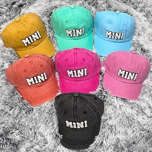 Detailed close-up of colorful washed cotton baseball caps with MINI embroidery