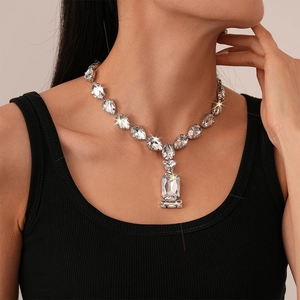 Luxury silver necklace with water drop links and large rectangular crystal on model
