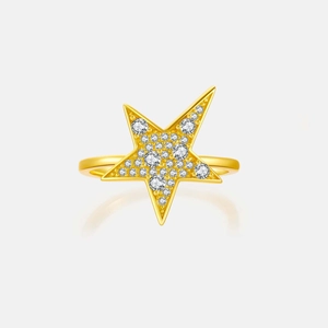 Macro shot of a gold star ring featuring sparkling zircon micro-paving and polished finish