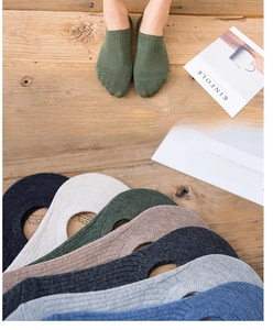 Detailed texture of combed cotton no-show socks in various vintage earth tone colors