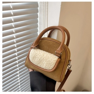 Detail of plush tote bag with brown faux suede texture and white fleece pocket