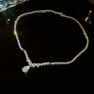 Macro shot of silver Y-shaped necklace with teardrop pendant and sparkling zircon stones