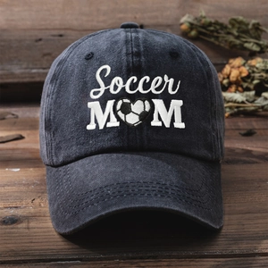 Detailed white Soccer MOM embroidery with heart football on washed black denim cap