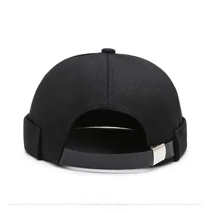 Detail of adjustable gray leather strap and silver metal buckle on black docker cap
