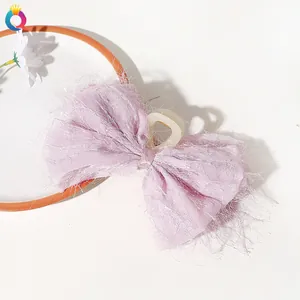 Macro shot of light purple chiffon bow hair claw with unique feather fringe texture
