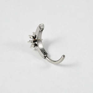 Macro shot of silver stainless steel curved barbell with star zircon inlay detail