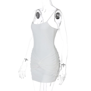 Detail of white ribbed knit mini dress featuring waist twist knot and pleated design