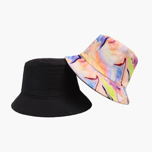 Two stylish bucket hats in black and tie-dye patterns for casual sun protection and fashion