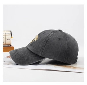 Detailed side view of washed cotton baseball cap with yellow New York embroidery