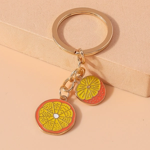 Fruit keychain featuring two enameled lemon and orange slice charms in vibrant colors