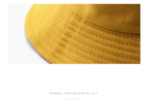 Detailed close-up showing precision stitching and twill texture on a ginger cotton bucket hat