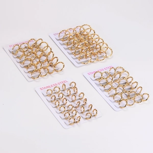 Golden twisted stainless steel hoop earrings set displayed on white background
