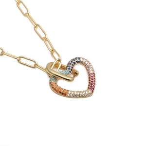 Gold paperclip chain necklace featuring a heart pendant with colorful rainbow zircons