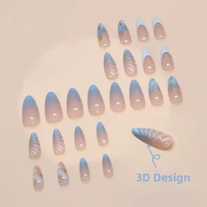 Detail view of almond press-on nails with 3D shell texture, blue gradient and gold foil