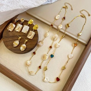 Detailed set of baroque pearl necklaces and earrings with colorful faceted gemstones