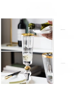 Macro detail of lead-free crystal champagne flute with gold rim and beaded stem