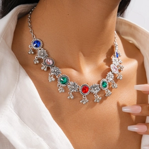 Detail of vintage flower necklace with colorful rhinestones and hanging metal beads