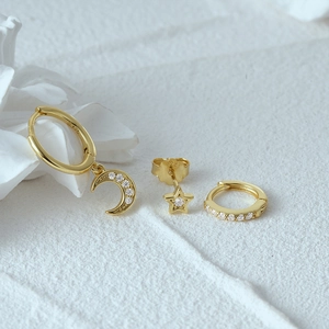 Detailed view of 925 sterling silver moon and star stud earring set with gold finish