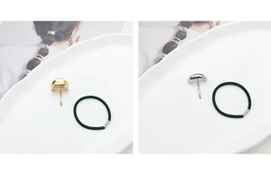 Close-up of minimalist gold and silver metal ponytail hair hooks with elastic bands