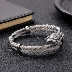 Close-up of vintage wolf head stainless steel braided cable bracelet with antique finish