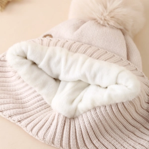 Winter beige knit hat for boys with plush lining and large faux fur pom-pom detail