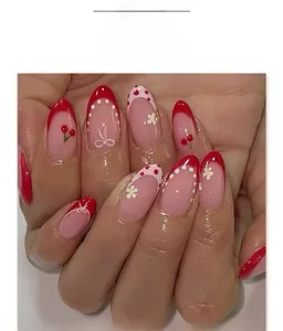Detailed view of French red almond nails with cherry prints and daisy relief patterns