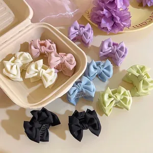 Sweet satin bow hair clips in multiple pastel colors presented in a gift box packaging
