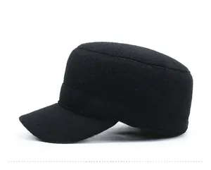 Detail of black winter cadet cap with metal sport logo and thickened fleece fabric