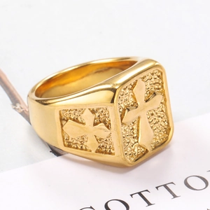 Macro view of gold vintage signet ring with engraved cross and textured metal band