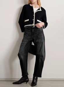 Close-up of vintage washed black high-waisted workwear jeans with functional patch pockets
