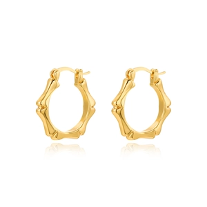 Macro detail of 18k gold-plated bamboo-shaped hoop earrings with secure latch back closure
