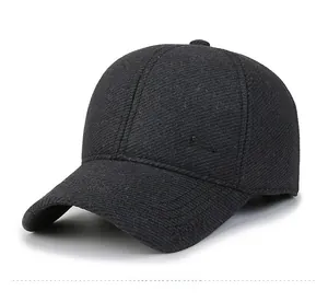 Detail of charcoal wool baseball cap with metal SPORT badge and twill texture