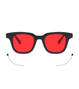 Close-up of matte black rectangular frames with vibrant red tinted fashion lenses