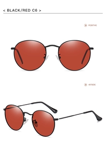 Close-up of retro round metal sunglasses with black frame and vibrant red lenses