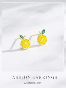 Detail of S925 sterling silver lemon earrings with yellow enamel and green cubic zirconia