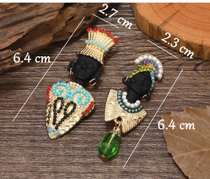 Ethnic style black portrait earrings with colorful beads and pearls on rustic wood