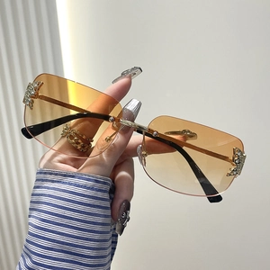 Y2K rimless butterfly sunglasses with orange gradient lenses and gold metal temples