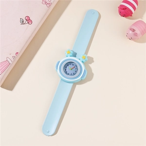 Detailed top view of light blue children slap watch with star pattern and cute accessories