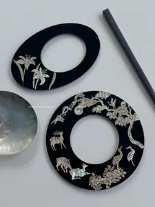 Close-up of raden lacquer hairpins with shell inlays of deer and crane motifs