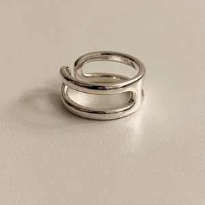 Detailed view of S925 sterling silver stamp on minimalist double-layer open ring band