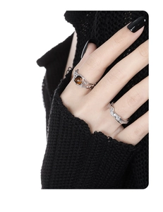 Detail of S925 silver rings with tiger eye stone and wave design worn on fingers